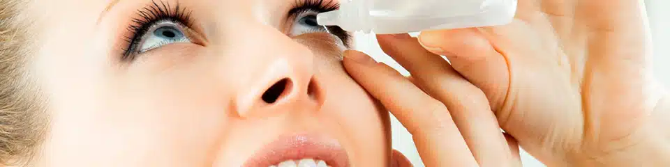 woman applying eye drops