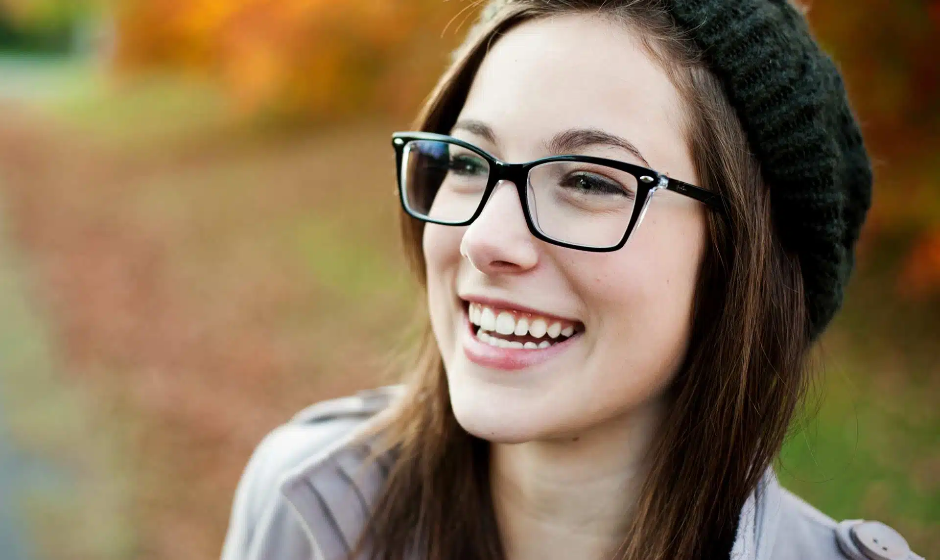 A woman wearing glasses outdoors