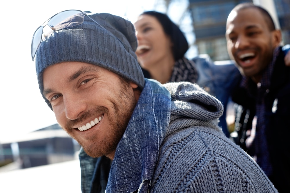 man smiling in the winter with glasses