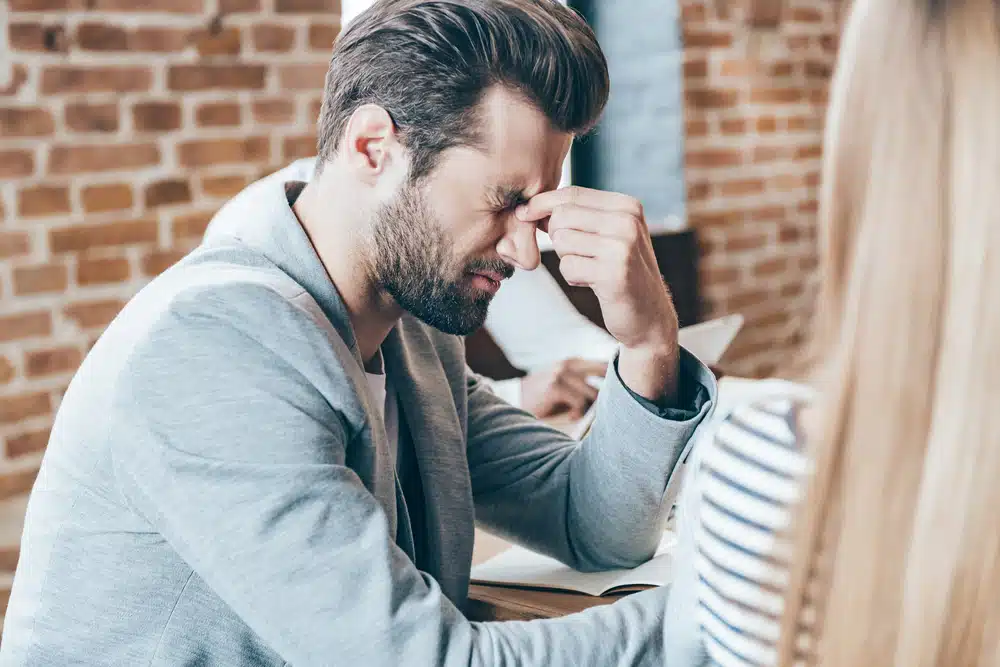 young man touching his eyes