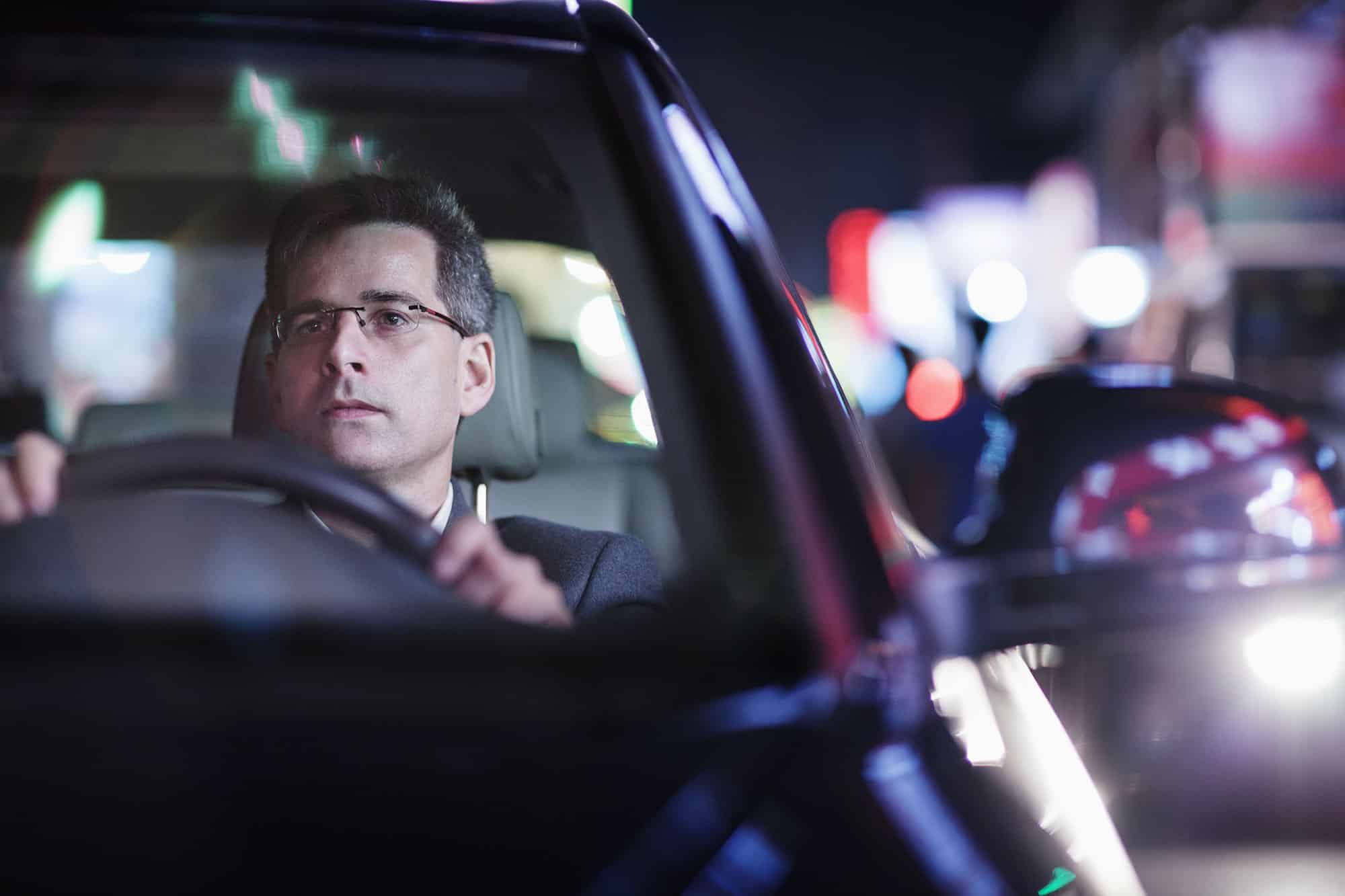 businessman driving in the night