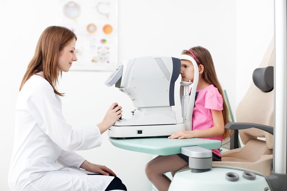 Optometrist examines the sight of a child