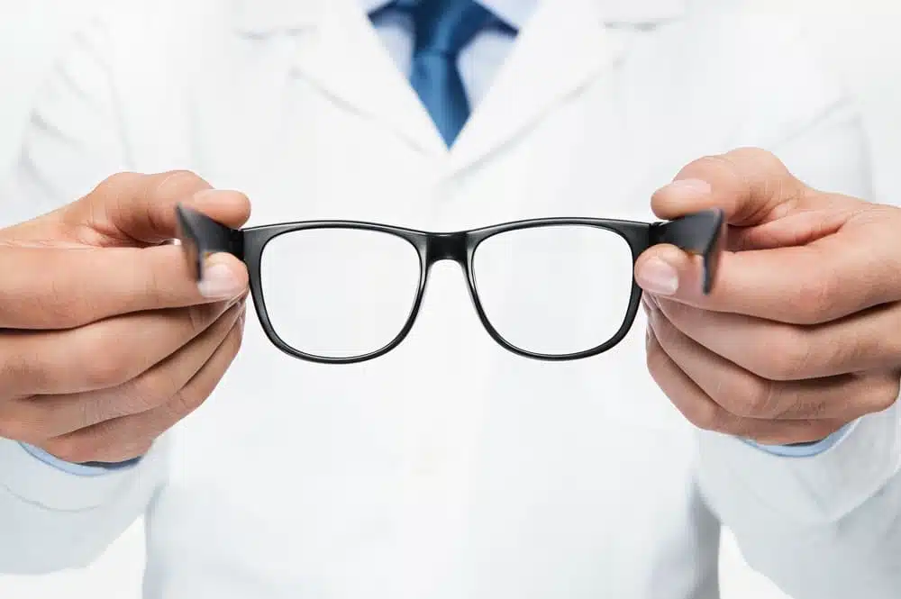 glasses held by an optometrist