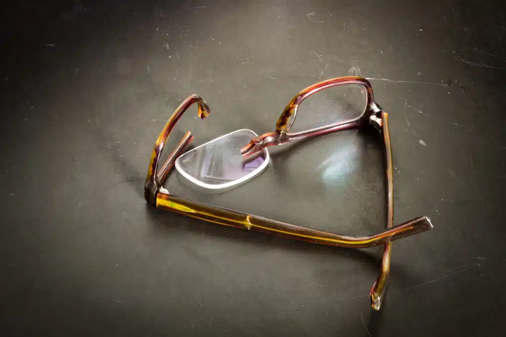 Broken cheap glasses laying on the ground