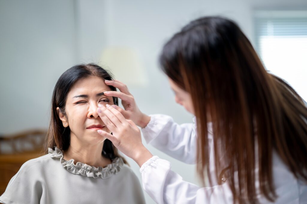 A,Woman,Is,Getting,Her,Eye,Checked,By,A,Doctor.